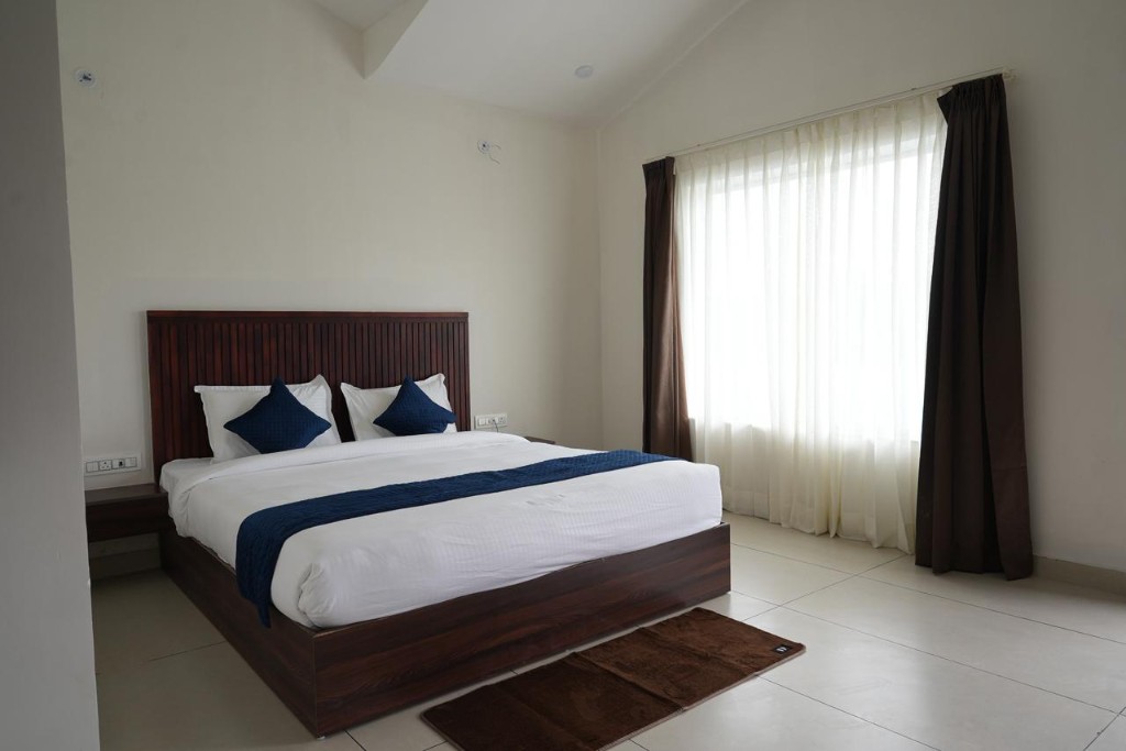 Adjacent cottages with blue trim under open sky