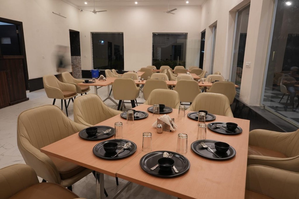 Hillside view of white and blue resort buildings from terrace