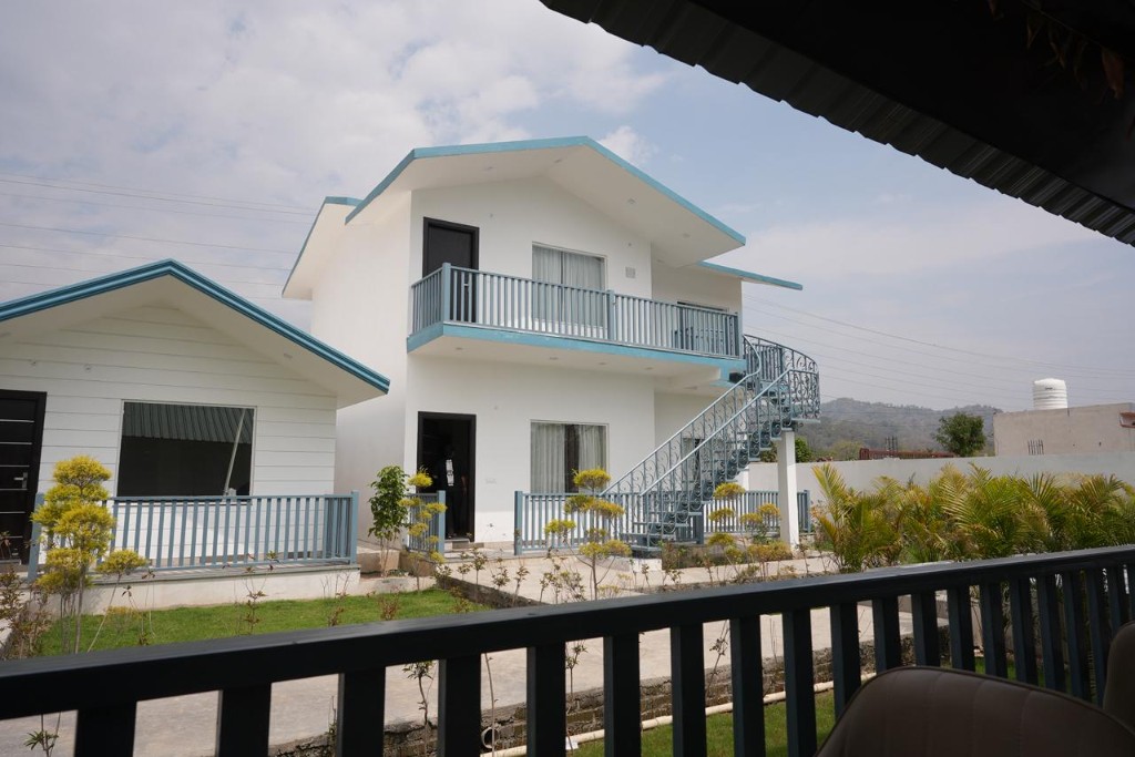 Dining area with wood tables and beige armchairs at night